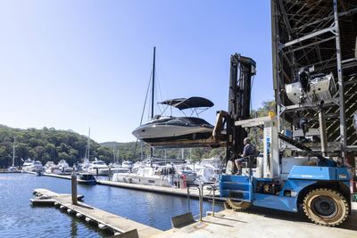forklift placing boat in water